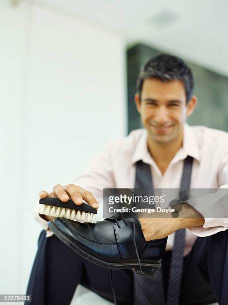 mid adult man polishing his shoes - 靴をみがく ストックフォトと画像