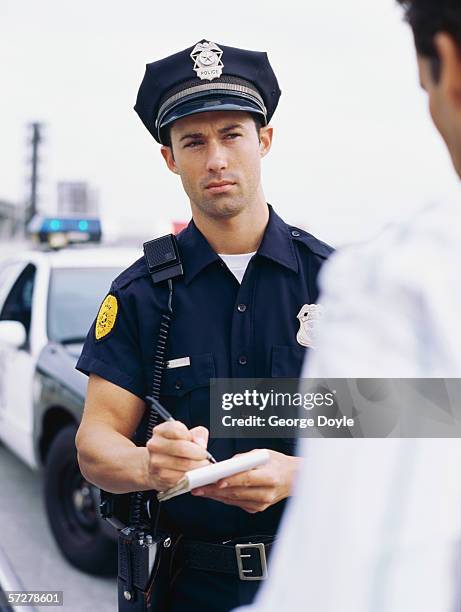 policeman interrogating and taking notes - bobby george stock pictures, royalty-free photos & images