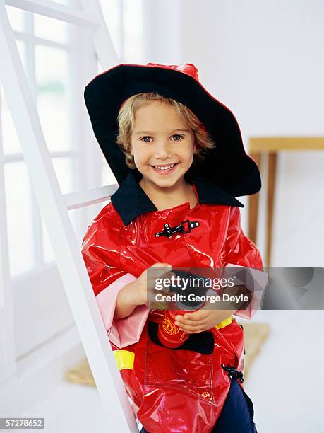 portrait of a boy pretending to be a fireman - boy fireman costume stock pictures, royalty-free photos & images