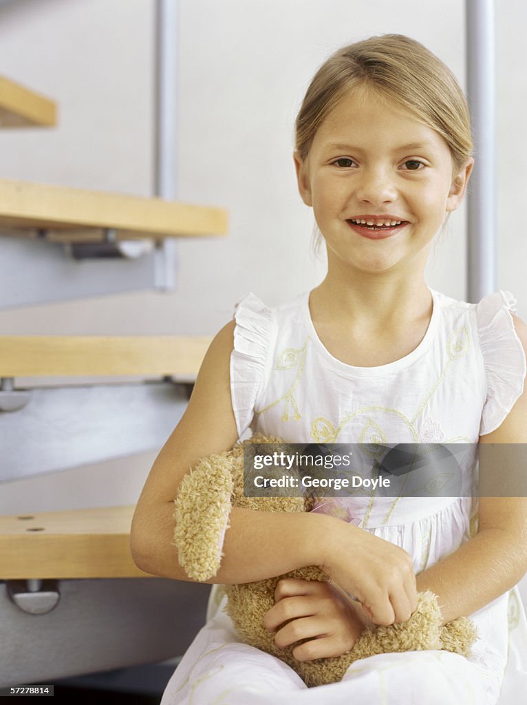 Portrait of a girl holding a teddy bear