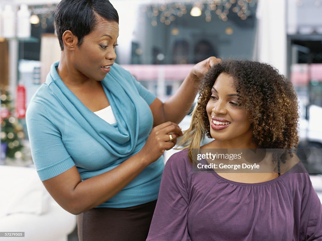 Close-up of a young woman and her hair stylist