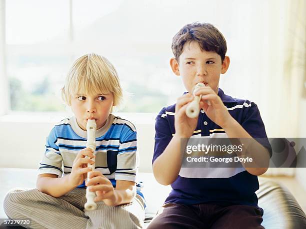 close-up of two boys playing the recorder - flauto dolce foto e immagini stock
