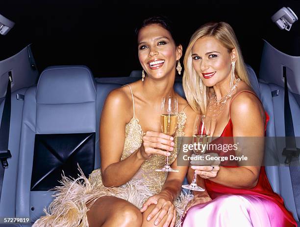 famous, successful women celebrating in limousine - abendgarderobe stock-fotos und bilder