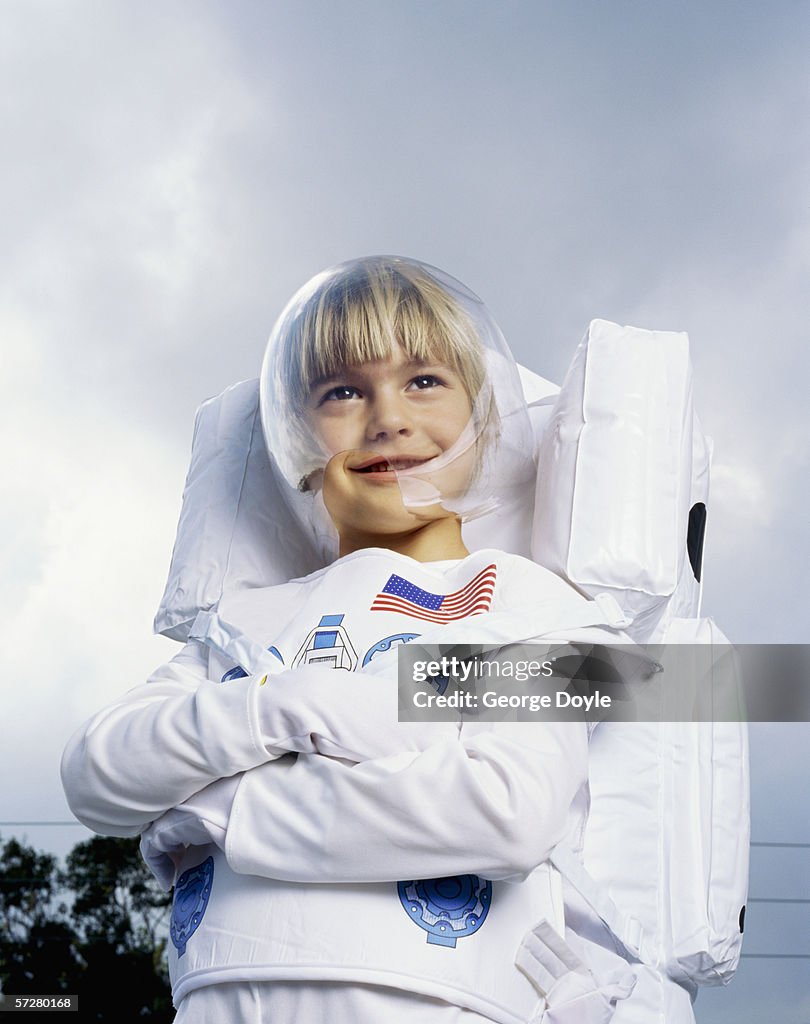 Low angle view of a boy pretending to be an astronaut