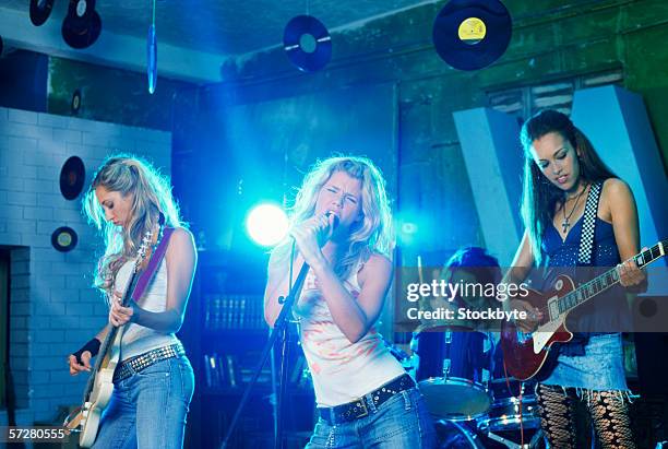 band playing in a club - girl band stock pictures, royalty-free photos & images