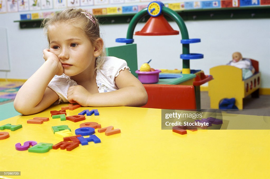 Girl sitting at the table in classroom