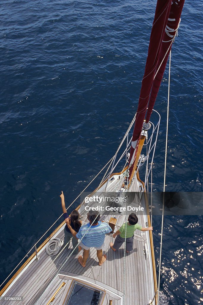 High angle view of a father with his two children on a sailboat