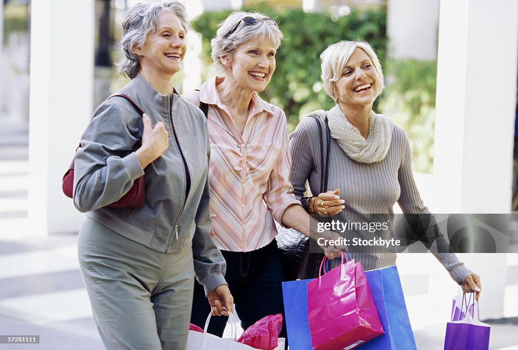 Three mature women walking and talking