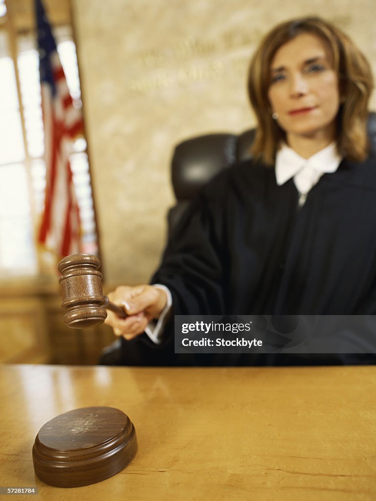 Close-up of a judge hitting the gavel against the sound block