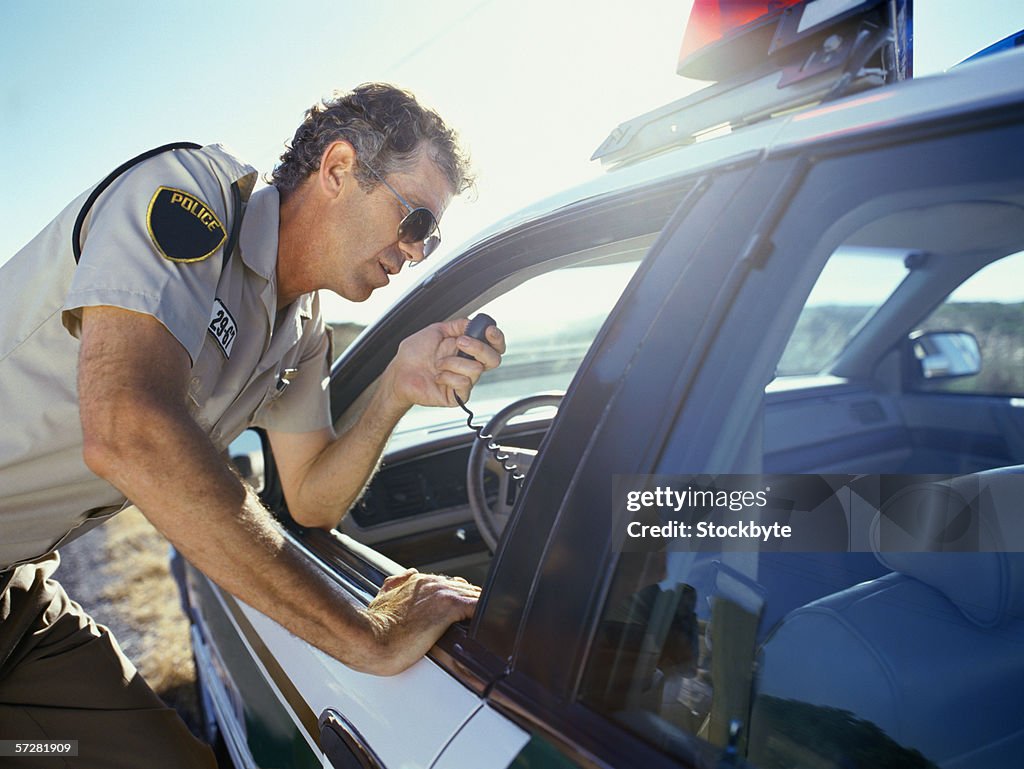Police Window Closeup Of A Policeman Standing Near A Car And Looking Through Window ...