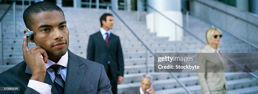 Businessman talking on a mobile phone earpiece