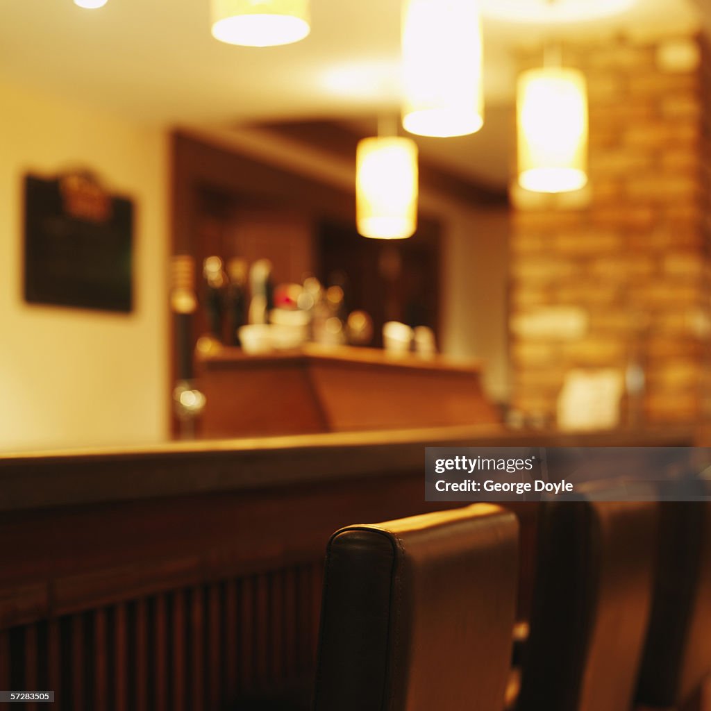 Close-up of bar counter and bar stools