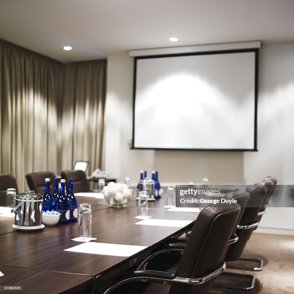 Close-up of boardroom table and projector screen