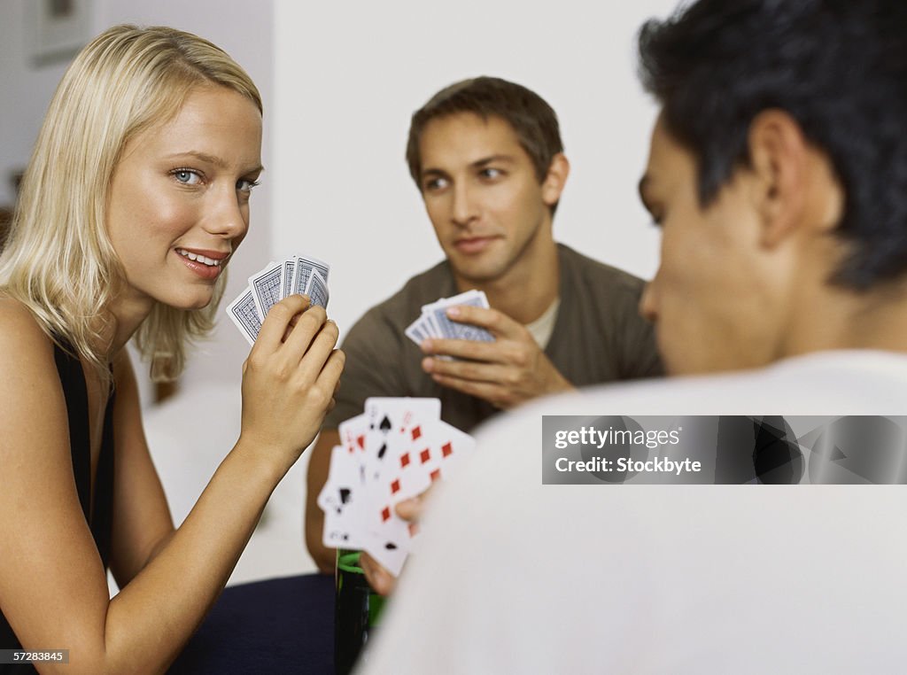 Side view of a young people playing cards
