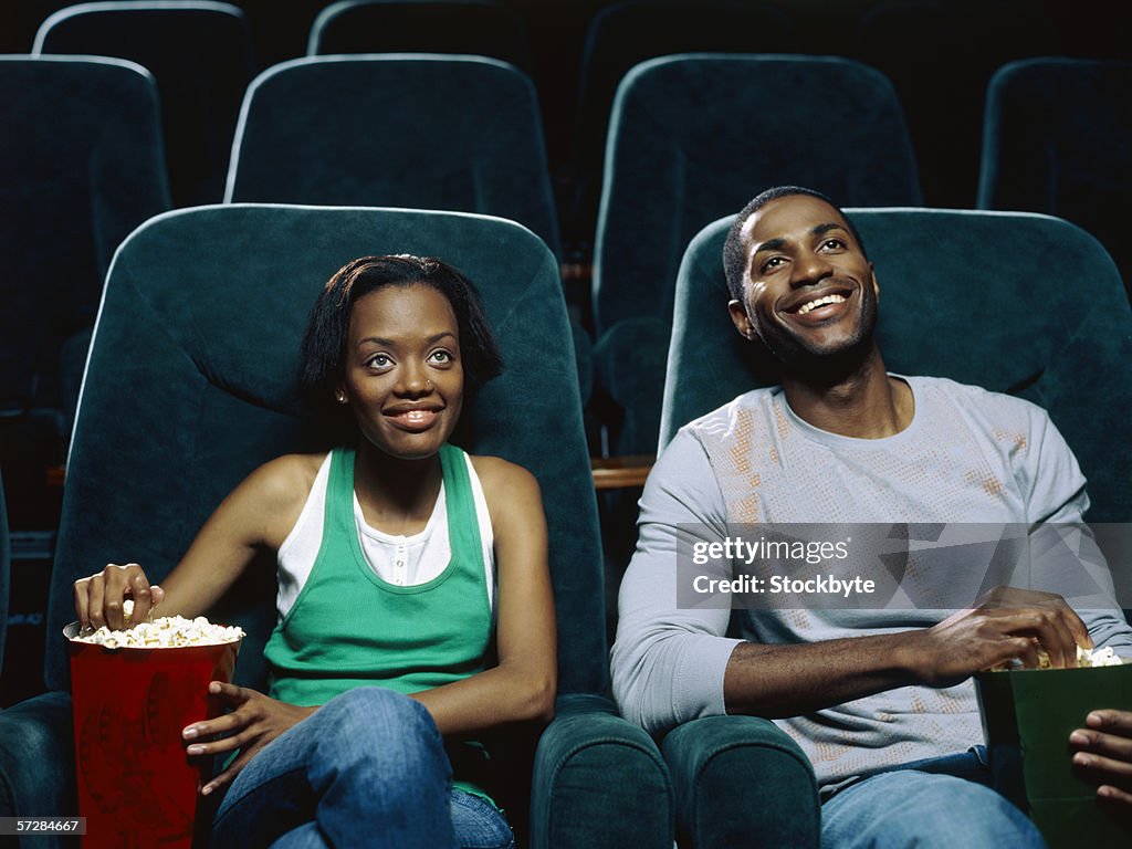 Young couple watching movie in a movie theatre