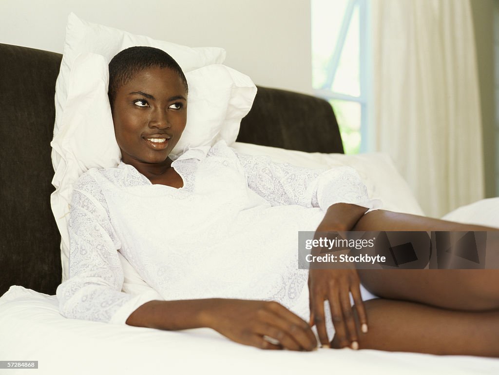 Young woman lying in bed