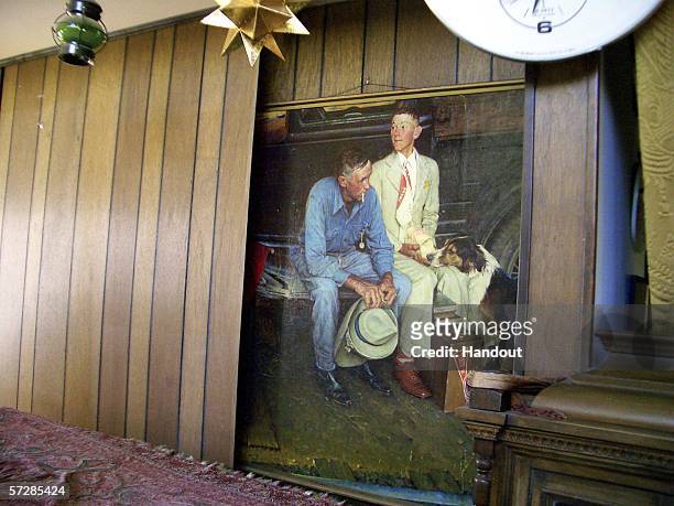 In this handout photo provided by the Norman Rockwell Museum, the orginal Norman Rockwell painting entitled "Breaking Home Ties" sits behind the fake...