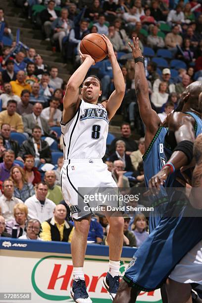 Deron Williams of the Utah Jazz puts up the shot over Marcus Banks of the Minnesota Timberwolves on April 07, 2006 at the Target Center in...