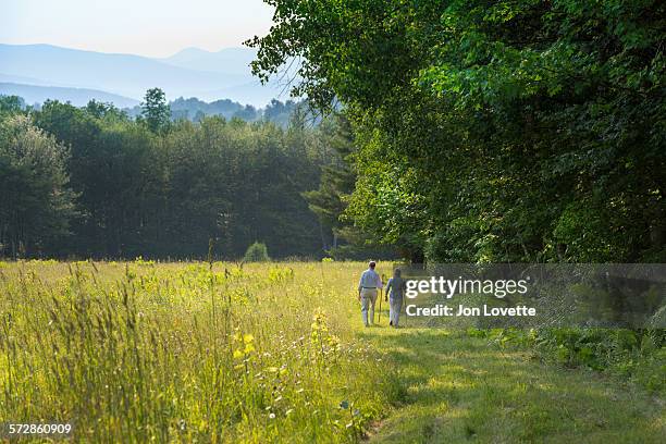 older couple walking - vermont imagens e fotografias de stock