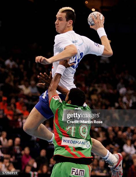 Joel Abati tries to stop Pascal Hens of Hamburg during the Handball DHB Cup Final Four match between SC Magdeburg and HSV Handball at the Colorline...