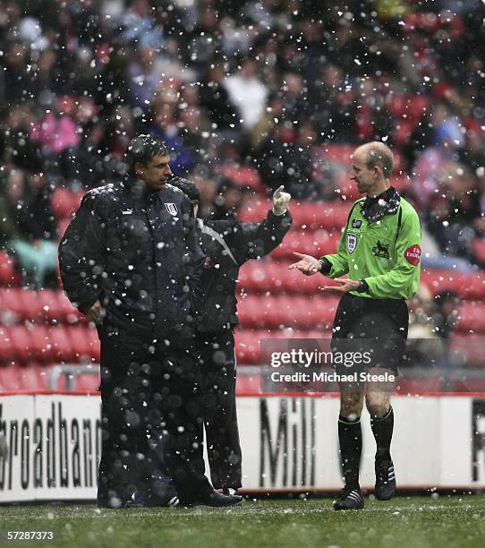 Referee Mike Riley consults Fulham manager Chris Coleman in heavy snow before abandoning the Barclays Premiership match between Sunderland and Fulham...