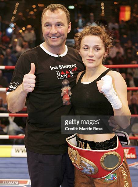 Ina Menzer of Germany and coach Michael Timm of Germany pose after winning the WIBF World Championship Featherweight fight between Ina Menzer of...