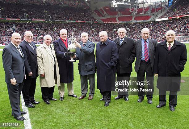 Members of the 1956 Manchester United Championship winning team pose with the League Championship trophy to commemorate the 50th anniversary of the...