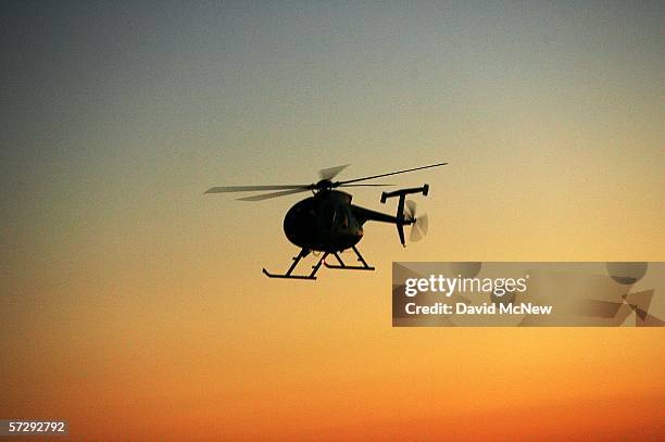 Border Patrol helicopter flies along the border after sunset as the Minuteman Civil Defense Corps patrols the U.S.-Mexico border in search of illegal...