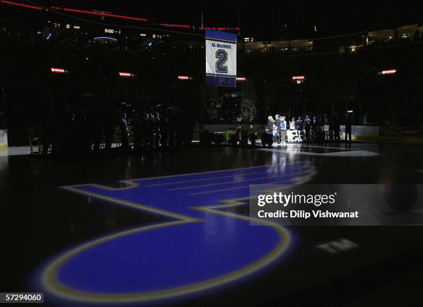 Former St. Louis Blues defenseman Al MacInnis and his family watch his banner being raised during his jersey retirement ceremony prior to the game...