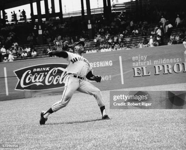 American baseball player Willie Mays of the San Francisco Giants winds up a throw to home plate during a road game, early 1960s.