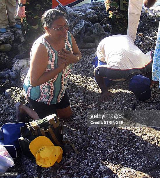 Chagosians kiss the soil of Salomon Island 10 April 2006. Some 102 Chagosians who were evicted from the idyllic Indian Ocean archipelago by Britain...