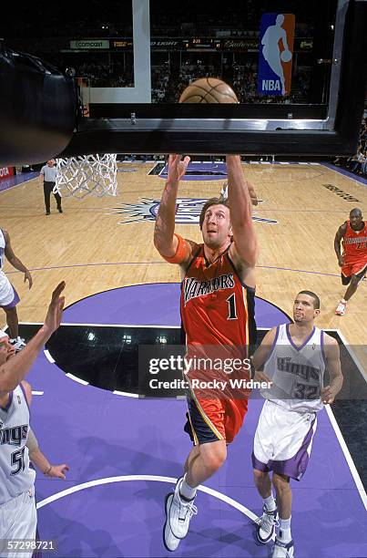 Troy Murphy of the Golden State Warriors reaches for the basket against Francisco Garcia of the Sacramento Kings during the game at Arco Arena on...