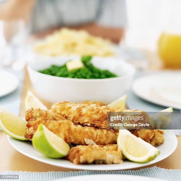 close-up of food on a dinner table - breaded chicken stock-fotos und bilder