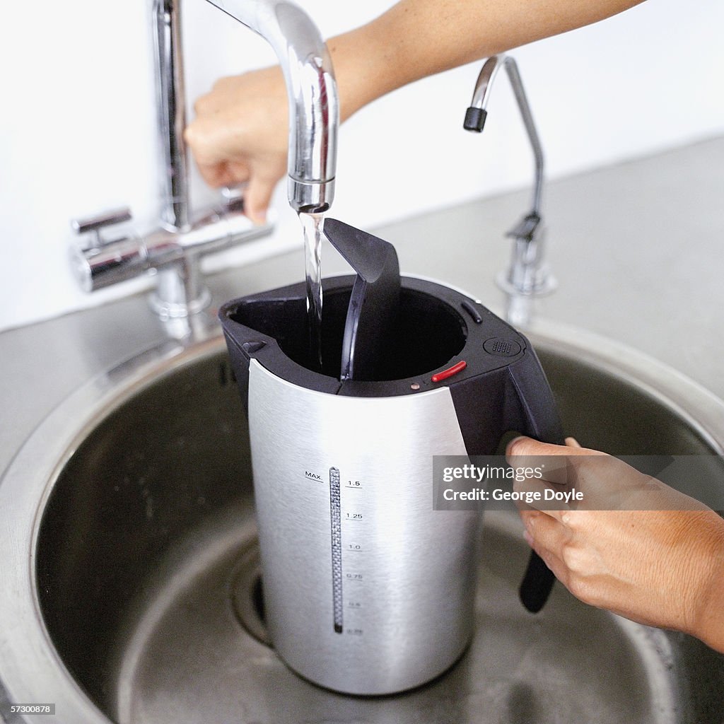 Close-up of an electric kettle being filled with water