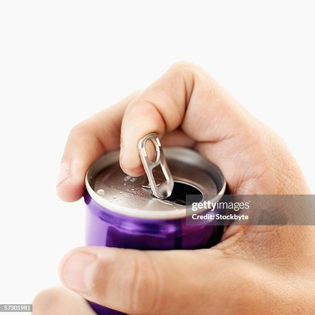 close-up of a man's hand opening a can - open tin can stock pictures, royalty-free photos & images