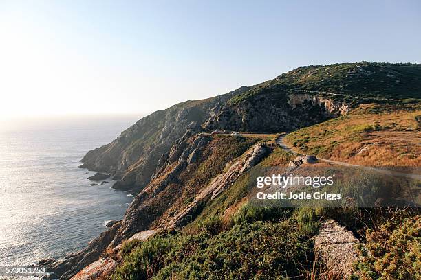 vehicles parked on rugged coastal headland - finisterre spagna foto e immagini stock