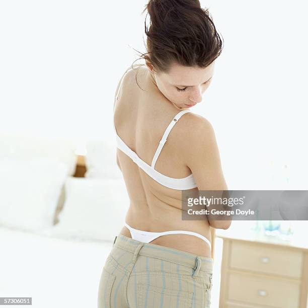 Young Woman Putting On Brarear View Photos and Premium High Res Pictures -  Getty Images