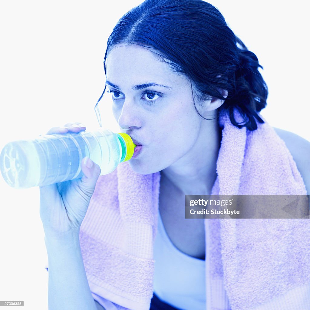 Young woman drinking water from a bottle