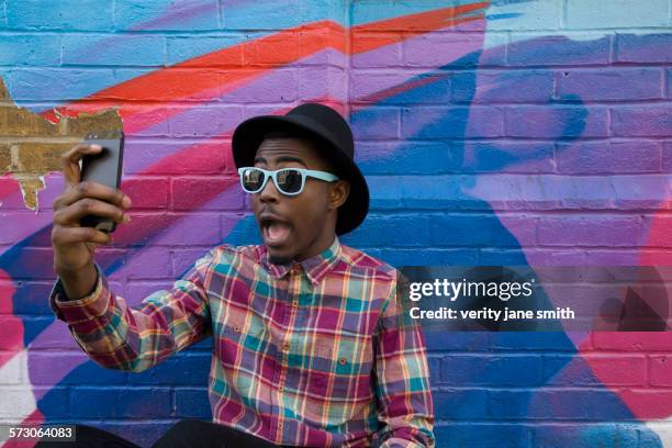 black man taking selfie near colorful wall - smart phone camera stock pictures, royalty-free photos & images
