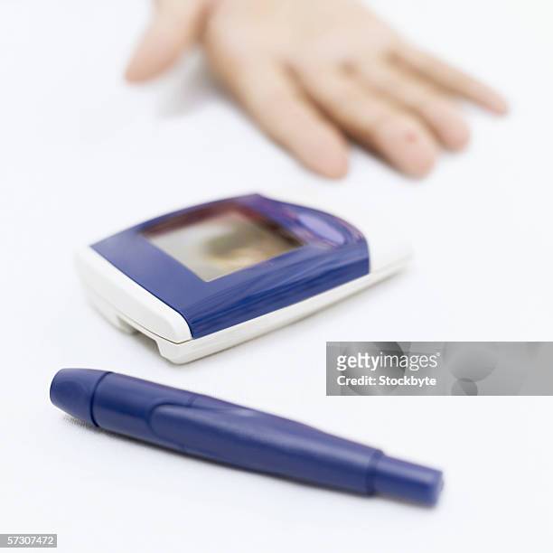 close-up of a digital thermometer and a digital glaucometer - glaucometer stockfoto's en -beelden