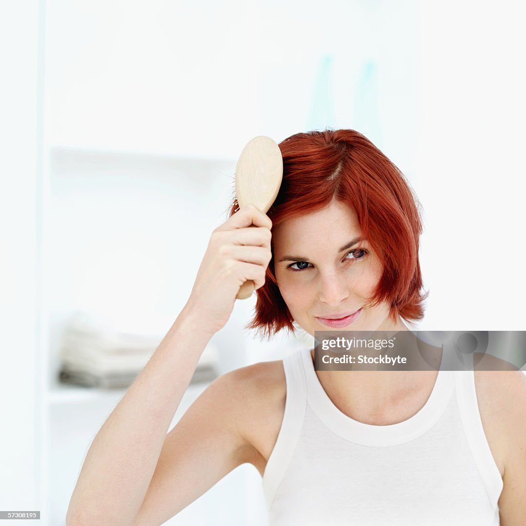 Young woman brushing hair