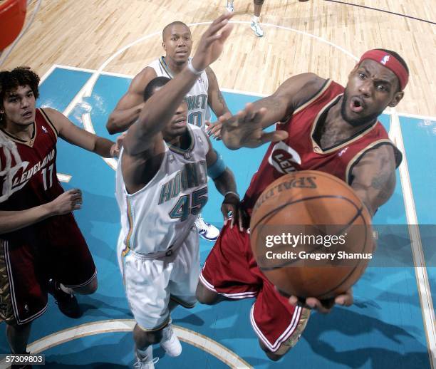 LeBron James of the Cleveland Cavaliers gets to the basket past Rasual Butler of the New Orleans/Oklahoma City Hornets during a NBA game on April 10,...