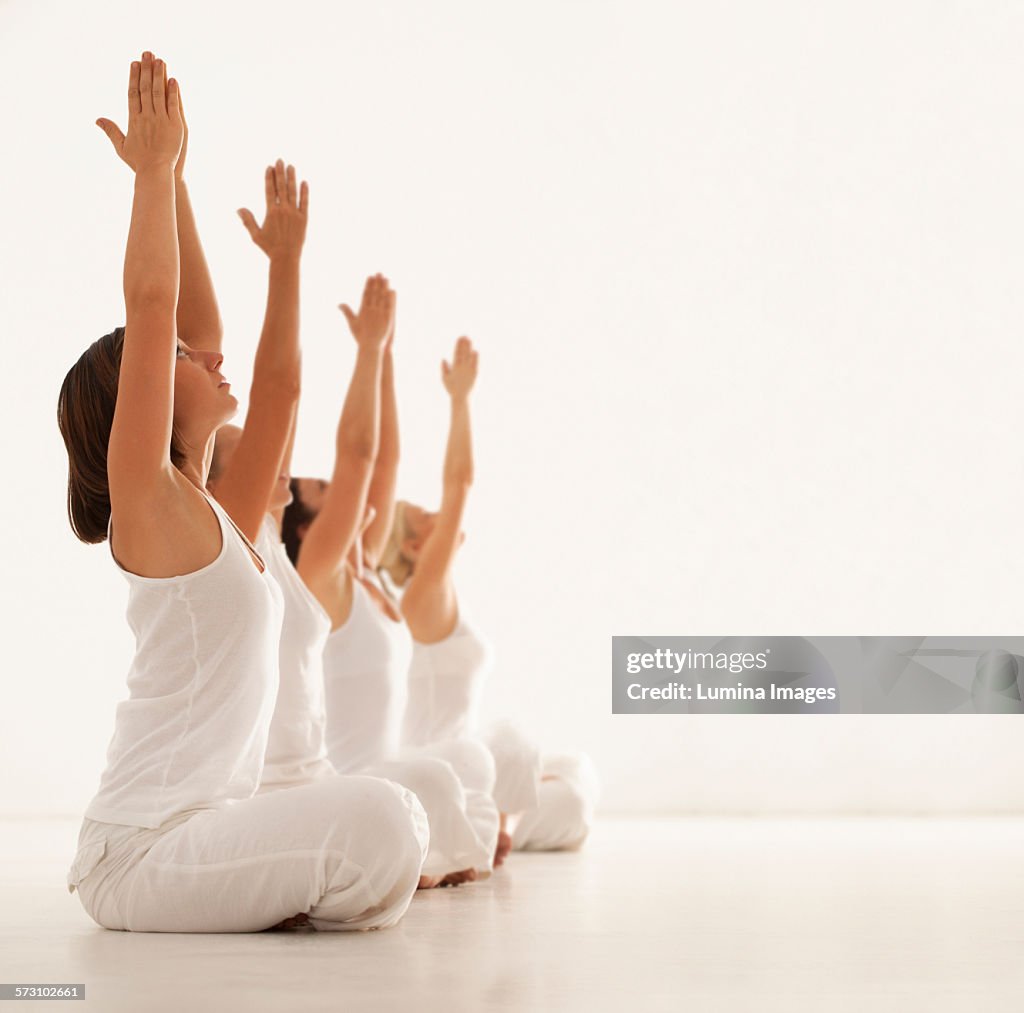 Women practicing yoga in class