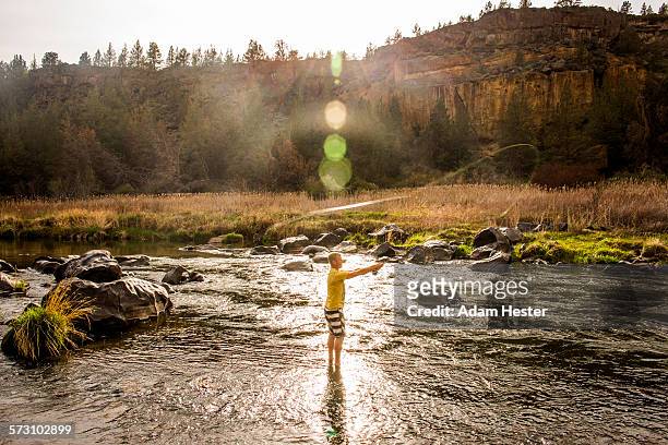 caucasian man fishing in remote river, smith rock state park, oregon, united states - smith rock state park stockfoto's en -beelden