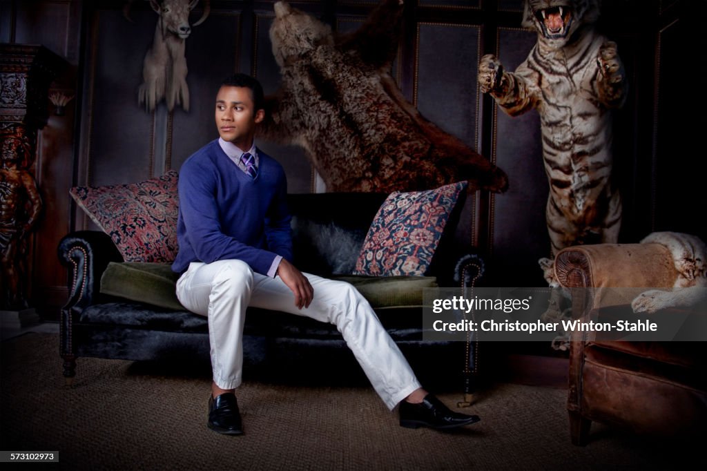 Man sitting in parlor with stuffed animals