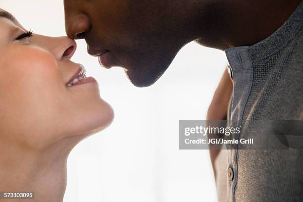 close up of smiling couple kissing - romantic couple on white background stock-fotos und bilder
