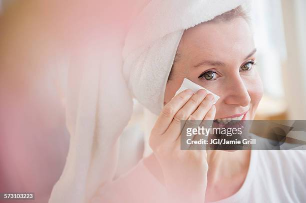caucasian woman wiping face - woman washing face stockfoto's en -beelden