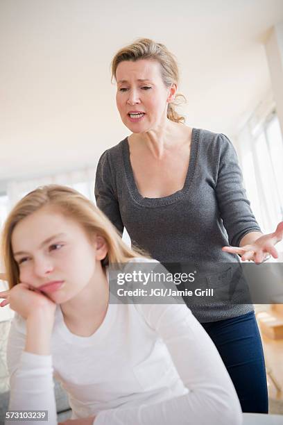 caucasian mother arguing with daughter - social projects address needs of struggling families stockfoto's en -beelden