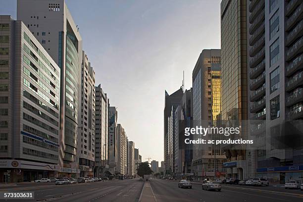 high rise buildings and street, abu dhabi emirate, united arab emirates - abu dhabi city stock pictures, royalty-free photos & images