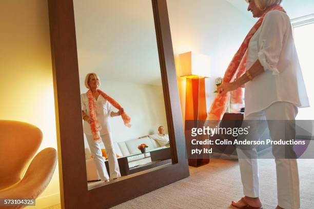 older caucasian woman admiring herself in mirror - senior getting dressed stock pictures, royalty-free photos & images